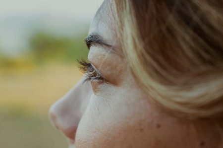 A closeup portrait of a young woman looking away from the camera